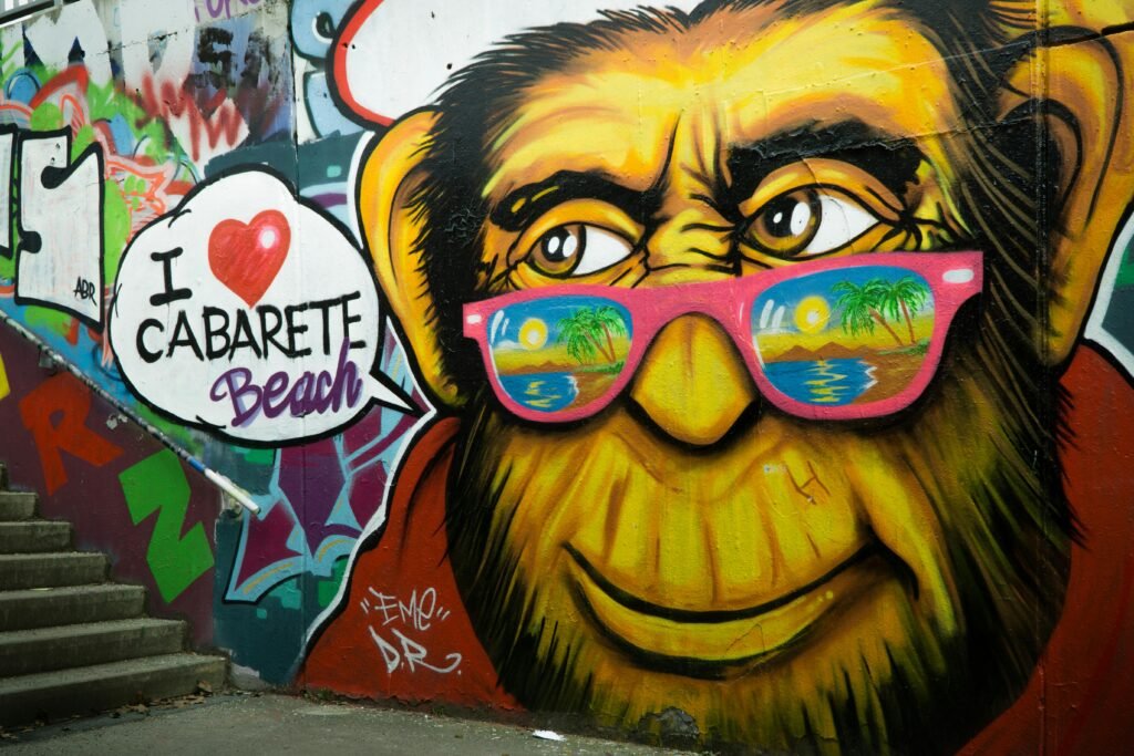 Colorful street art of a monkey with sunglasses on stairs, featuring Cabarete Beach text.